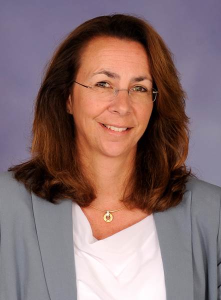 Headshot of Linda Mullen, a woman smiling wearing glasses and a gray blazer