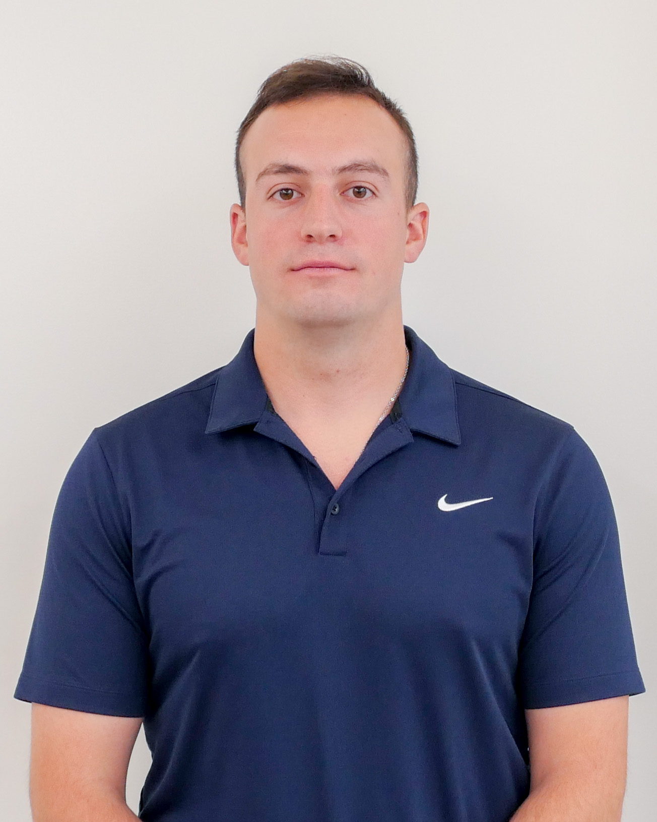 Headshot of Ryan Lowe, a man with short hair wearing a dark blue polo
