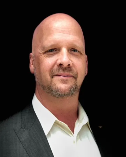 Headshot of Jim Bolin, a man smiling wearing a gray jacket and white shirt