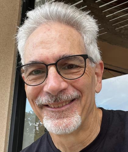 Headshot of Bob Gleichauf, a man smiling wearing black glasses and a black shirt