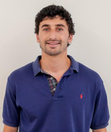 Headshot of Jacob Safeer, smiling and wearing an indigo polo